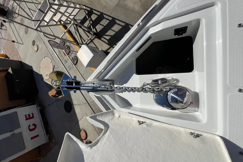 Slide: The Image of Bow anchor compartment of 2026 Crownline 310 XSS boat, featuring a polished anchor chain. - 30