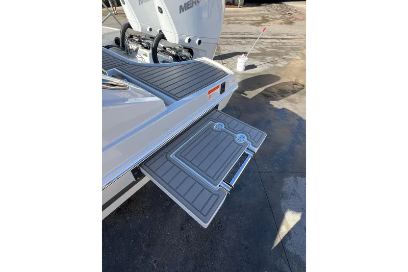 Slide: The Image of 2026 Crownline 310 XSS boat with extended swim platform and dual Mercury engines. - 9