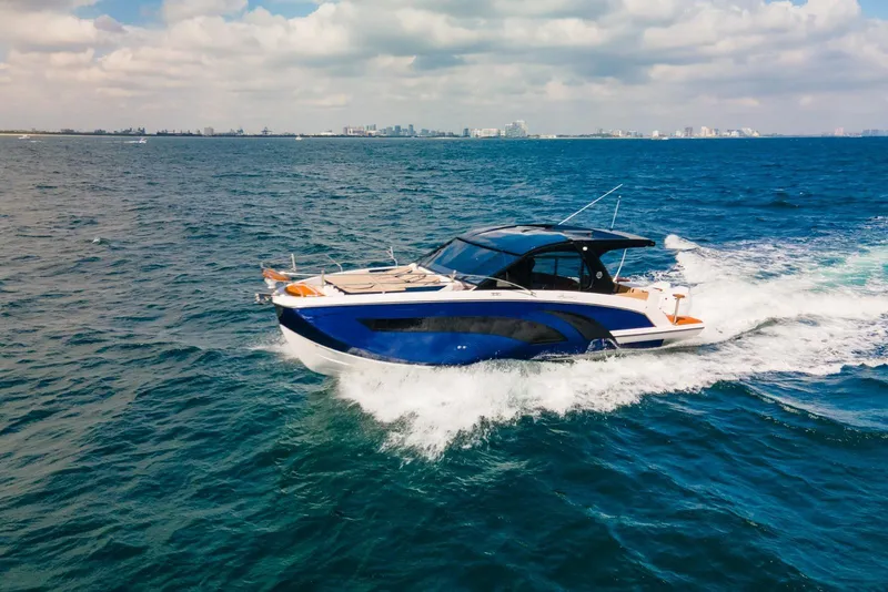 The Image of 2024 Hanover 387 yacht cruising on open sea under a partly cloudy sky. - 0