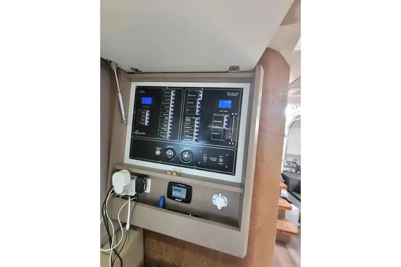 Slide: The Image of Control panel inside 2024 Hanover 387 vehicle, featuring various switches and gauges. - 11