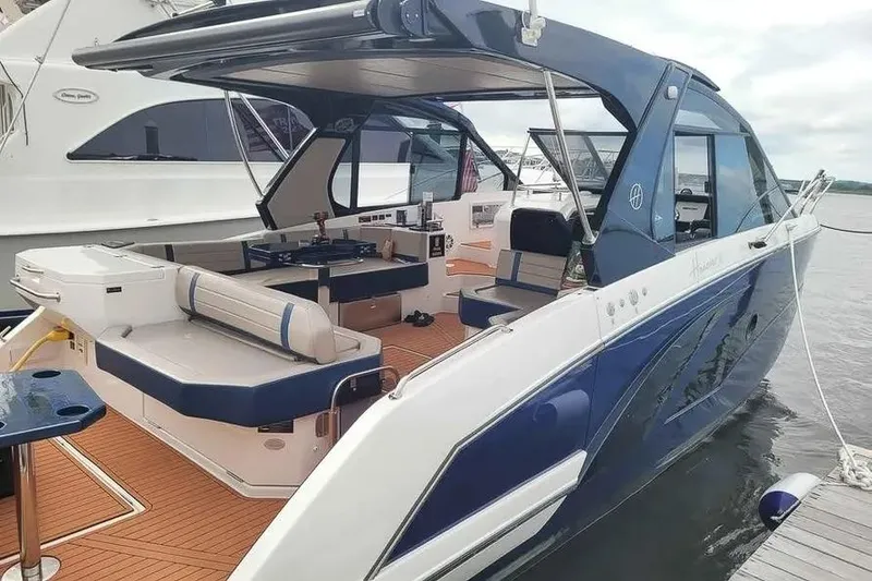 Slide: The Image of 2024 Hanover 387 yacht with sleek design, spacious deck, and modern amenities docked by the water. - 12
