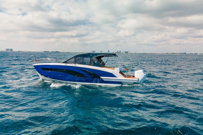 Slide: The Image of 2024 Hanover 387 boat cruising on open sea under cloudy sky. - 2