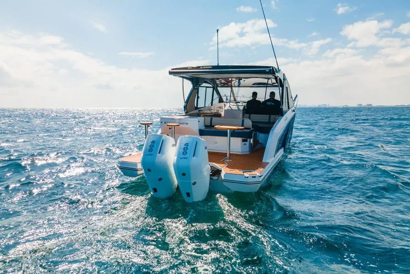 Slide: The Image of 2024 Hanover 387 boat cruising on open sea under clear blue sky. - 3