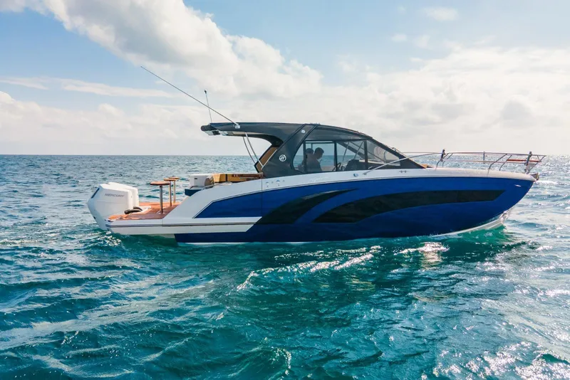 Slide: The Image of 2024 Hanover 387 boat cruising on open sea under a partly cloudy sky. - 4