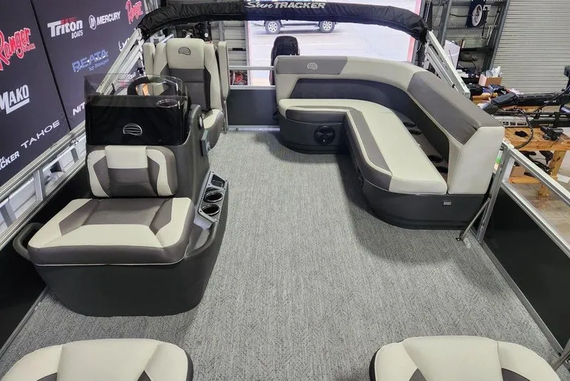 Slide: The Image of 2026 Sun Tracker Bass Buggy 16 XL Select pontoon boat interior with seating and helm. - 5