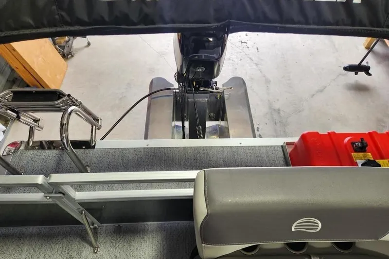 Slide: The Image of 2026 Sun Tracker Bass Buggy 16 XL Select interior with motor and seating view. - 9