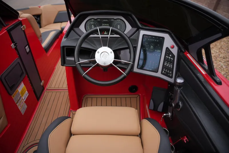Slide: The Image of 2022 MasterCraft XStar S boat cockpit with modern steering and digital controls. - 12