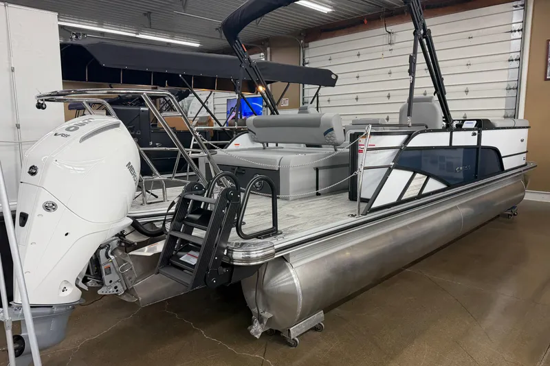 Slide: The Image of 2026 Crest Conquest 250 SLSC pontoon boat with Mercury V8 engine in showroom. - 14