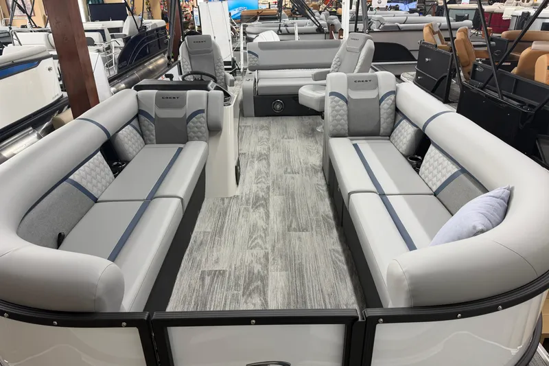 Slide: The Image of Luxurious interior of 2026 Crest Conquest 250 SLSC pontoon boat with plush seating. - 2
