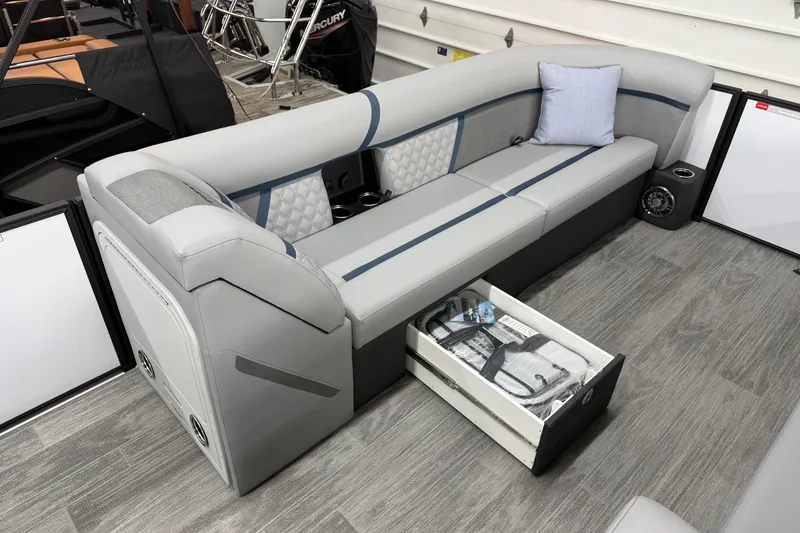 Slide: The Image of 2026 Crest Conquest 250 SLSC boat interior with gray seating, storage drawer, and modern design. - 6