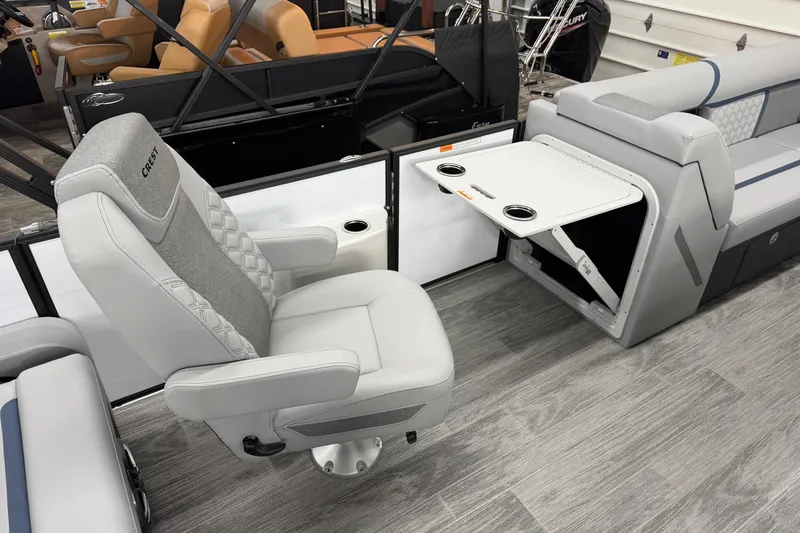 Slide: The Image of 2026 Crest Conquest 250 SLSC boat interior with swivel chair and foldable table. - 7