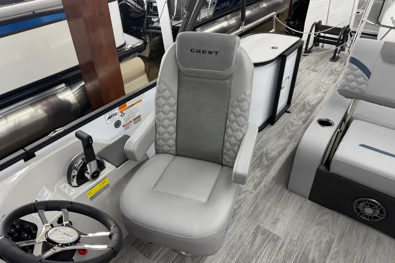 Slide: The Image of Captain's chair in 2026 Crest Conquest 250 SLSC boat, featuring sleek design and modern controls. - 8