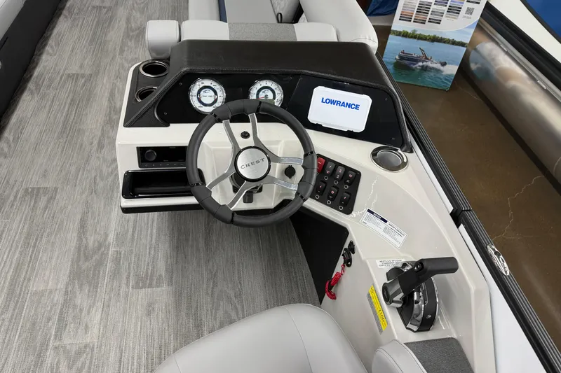 Slide: The Image of 2026 Crest Conquest 250 SLSC boat dashboard with steering wheel and control panel. - 9