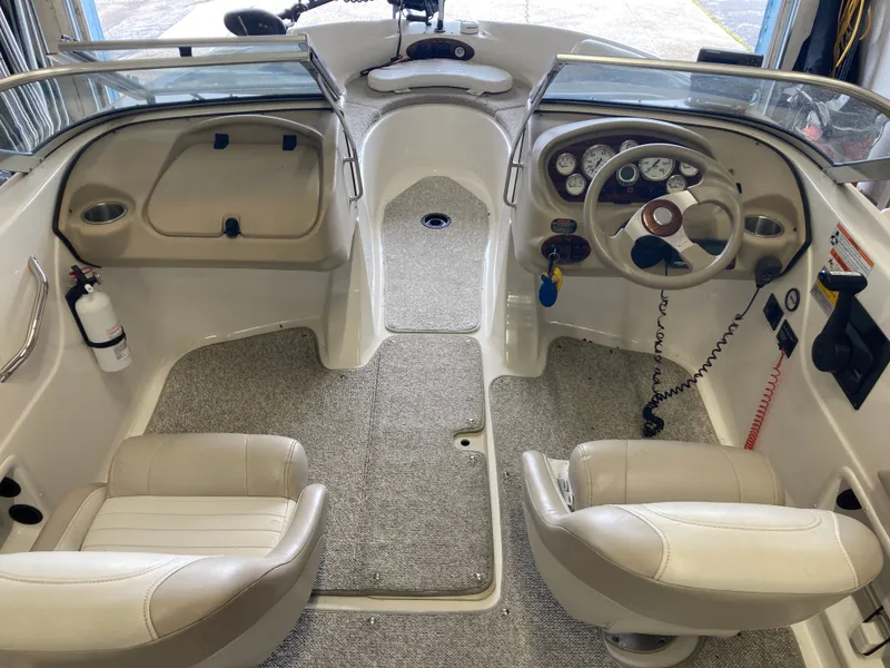 Slide: The Image of Interior of a 2007 Glastron GT 205 boat with steering console. - 11
