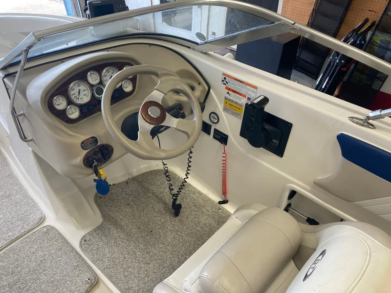 Slide: The Image of Interior view of a 2007 Glastron GT 205 boat with steering console. - 12