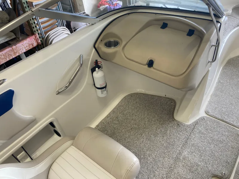 Slide: The Image of Interior of a 2007 Glastron GT 205 boat with seat and fire extinguisher. - 14