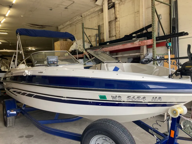 Slide: The Image of 2007 Glastron GT 205 boat in warehouse, blue and white design. - 4