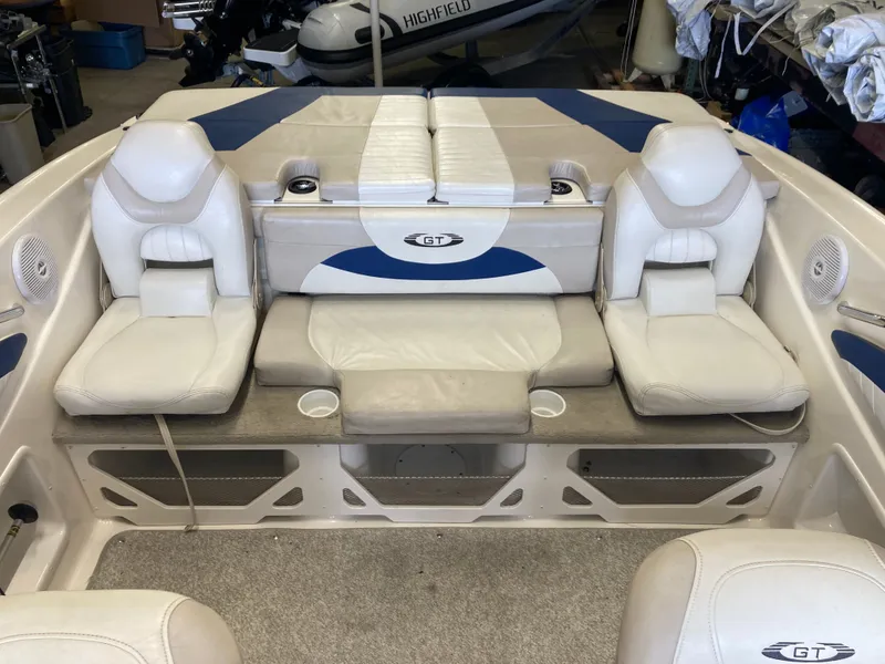Slide: The Image of Interior of a 2007 Glastron GT 205 boat with white seating. - 7