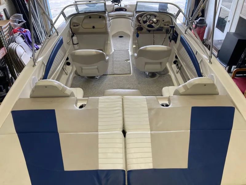 Slide: The Image of Interior of a 2007 Glastron GT 205 boat with blue and white seating. - 9