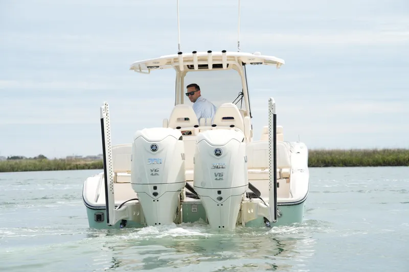 Slide: The Image of 2024 Grady-White 281 Coastal Explorer boat cruising on water with dual engines. - 10