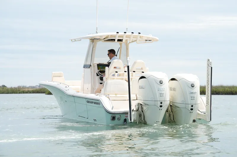 Slide: The Image of 2024 Grady-White 281 Coastal Explorer boat with dual Yamaha engines on calm water. - 12