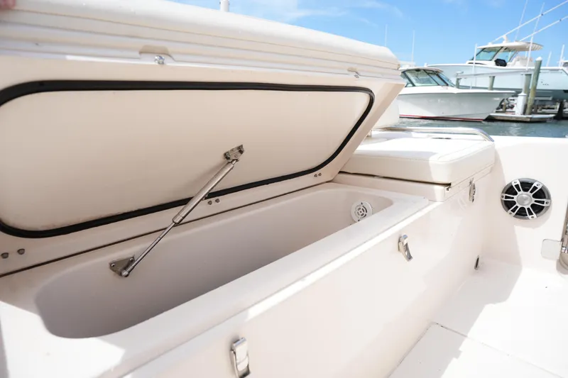 Slide: The Image of 2024 Grady-White 281 Coastal Explorer boat storage compartment open at marina. - 17