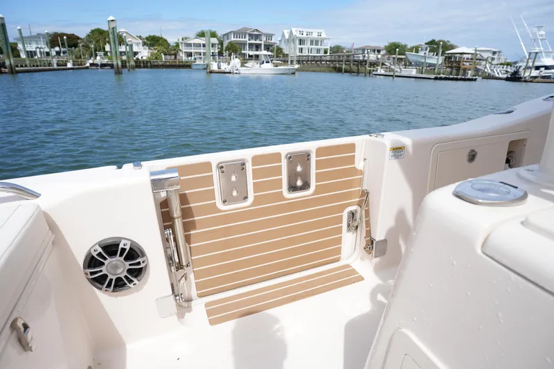 Slide: The Image of 2024 Grady-White 281 Coastal Explorer boat interior with water view and docked houses. - 22