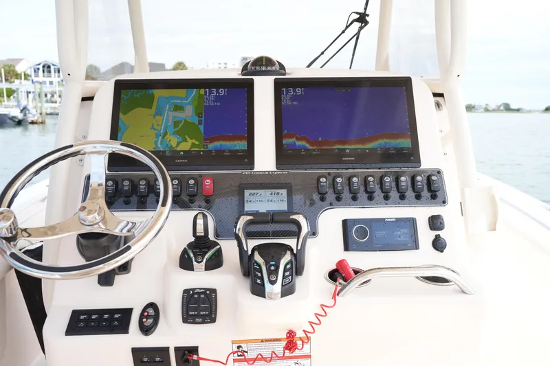 Slide: The Image of 2024 Grady-White 281 Coastal Explorer helm with dual Garmin displays and controls. - 25