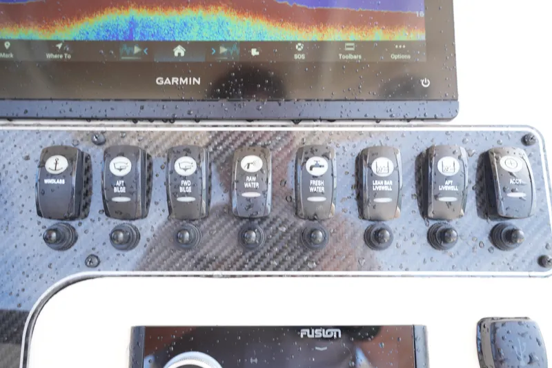 Slide: The Image of Control panel of 2024 Grady-White 281 Coastal Explorer with Garmin display and switches. - 27
