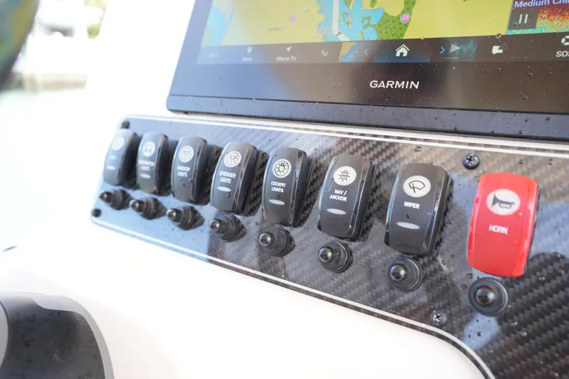 Slide: The Image of Control panel of 2024 Grady-White 281 Coastal Explorer with Garmin display and switches. - 28