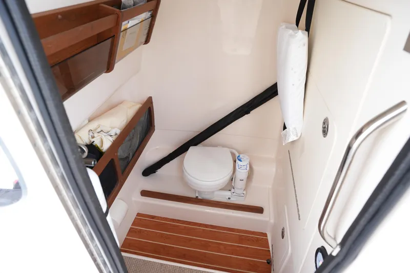 Slide: The Image of 2024 Grady-White 281 Coastal Explorer boat interior with compact bathroom amenities. - 32