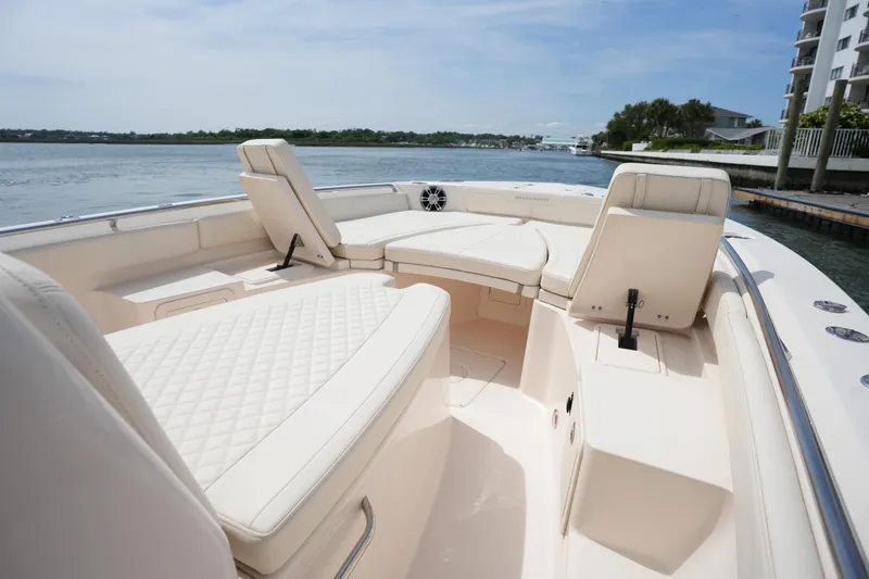 Slide: The Image of 2024 Grady-White 281 Coastal Explorer boat interior with luxurious seating and waterfront view. - 33