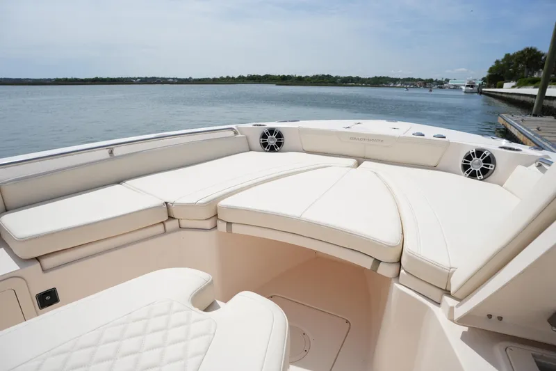 Slide: The Image of 2024 Grady-White 281 Coastal Explorer boat interior with cushioned seating and scenic water view. - 37