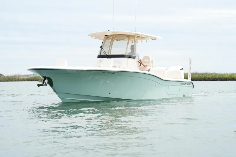 Slide: The Image of 2024 Grady-White 281 Coastal Explorer boat on calm water. - 4