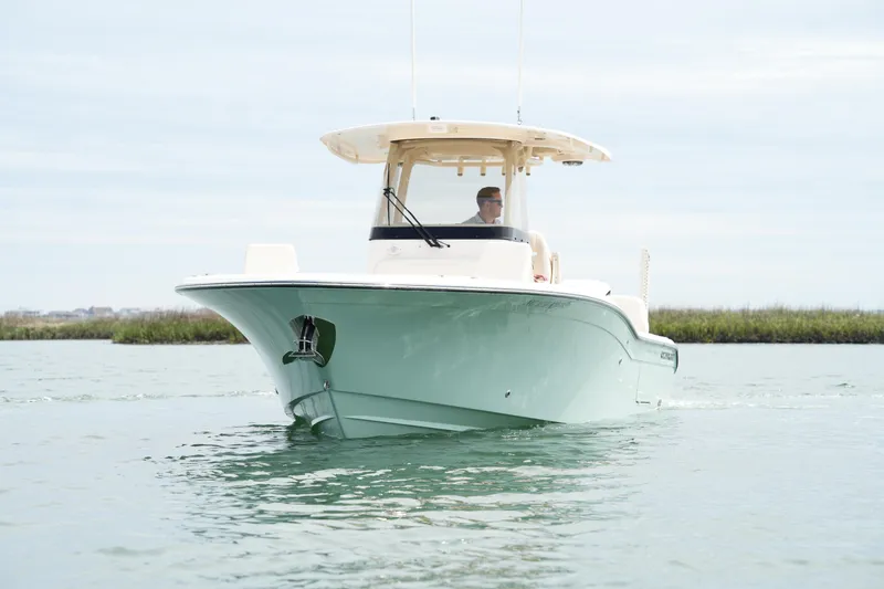 Slide: The Image of 2024 Grady-White 281 Coastal Explorer boat cruising on calm water. - 5