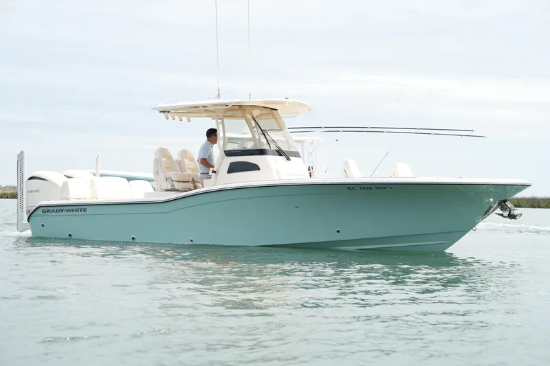 Slide: The Image of 2024 Grady-White 281 Coastal Explorer boat cruising on calm waters. - 8