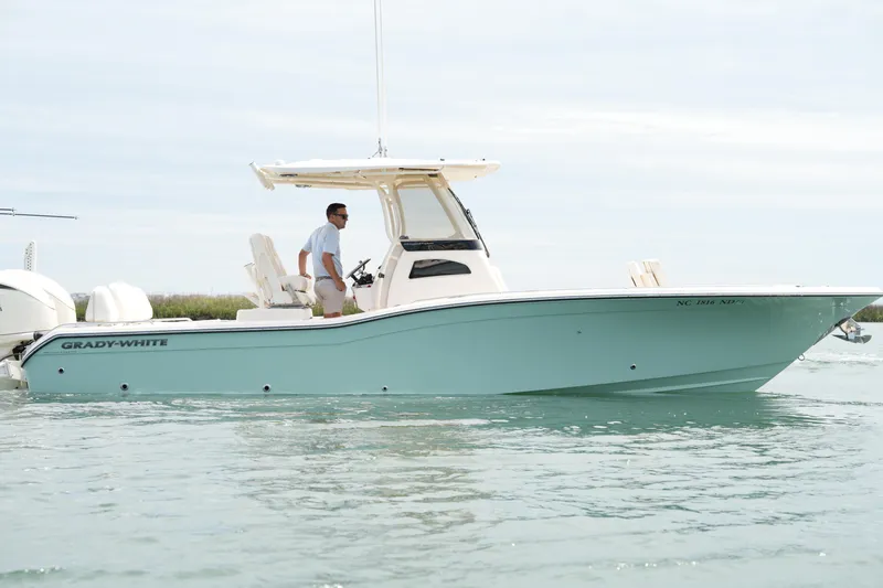 Slide: The Image of 2024 Grady-White 281 Coastal Explorer boat cruising on calm waters. - 9