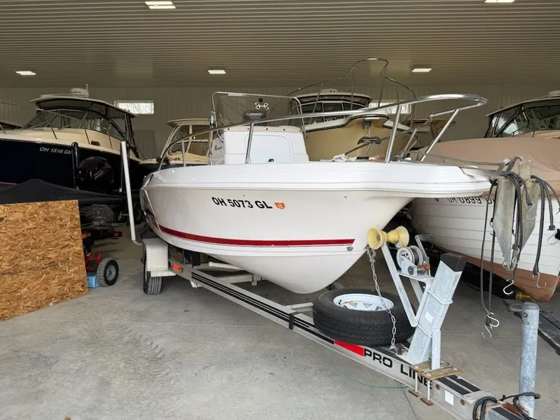 The Image of 2000 Pro-Line 21 Walkaround boat stored indoors. - 0