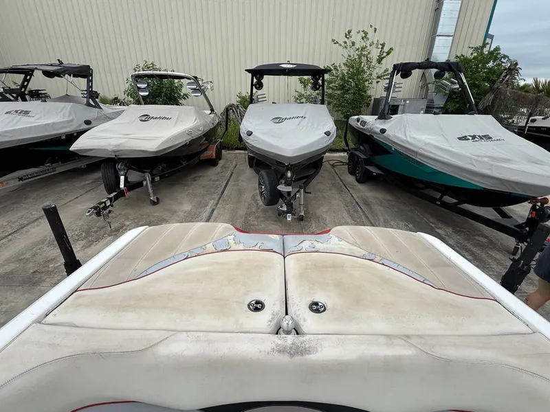 Slide: The Image of Malibu Wakesetter 23 LSV 2010 boats parked in a lot. - 23