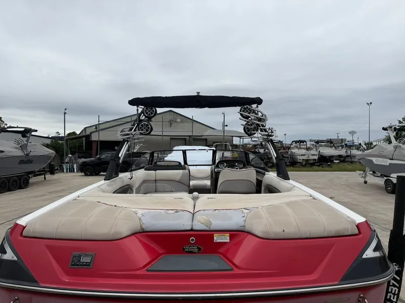 Slide: The Image of 2010 Malibu Wakesetter 23 LSV boat in a parking lot. - 25
