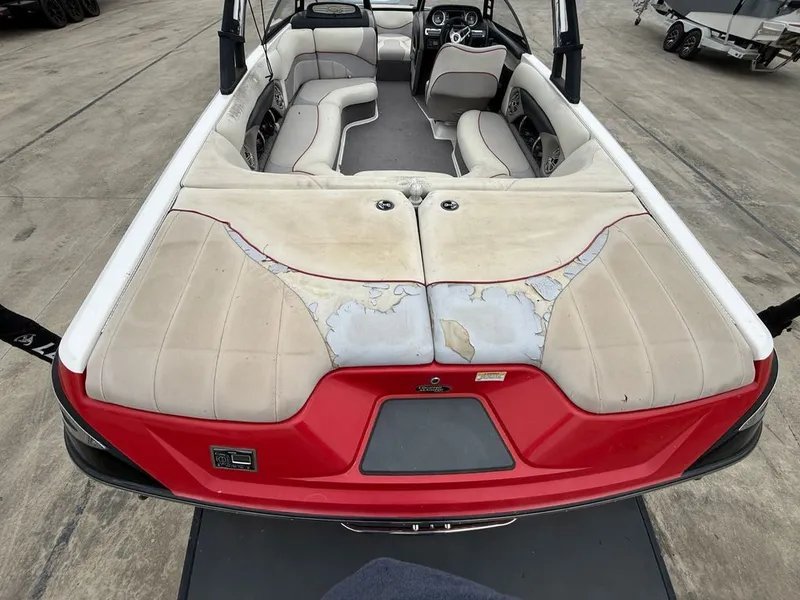 Slide: The Image of Interior of a 2010 Malibu Wakesetter 23 LSV with worn seats. - 26