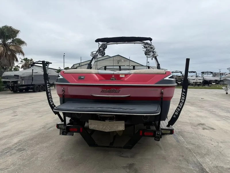 Slide: The Image of Red 2010 Malibu Wakesetter 23 LSV boat in a parking lot. - 27