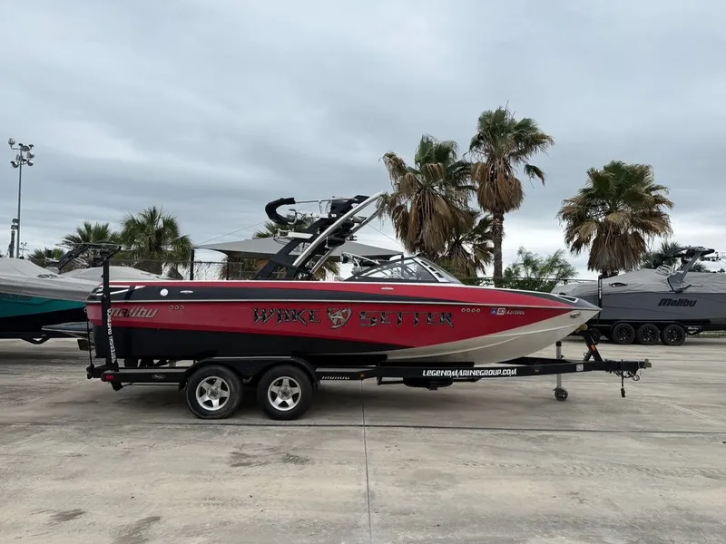 Slide: The Image of 2010 Malibu Wakesetter 23 LSV boat on trailer, palm trees in background. - 29