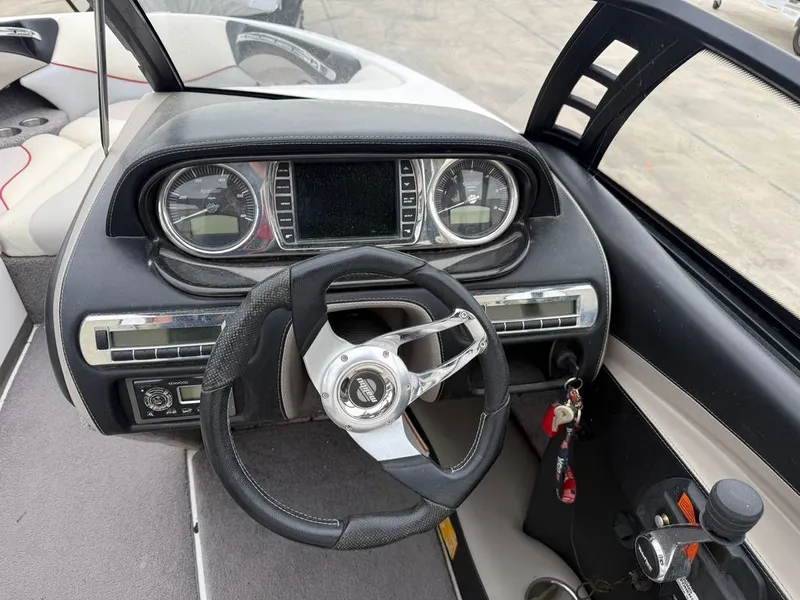 Slide: The Image of 2010 Malibu Wakesetter 23 LSV cockpit with steering wheel and dashboard. - 7