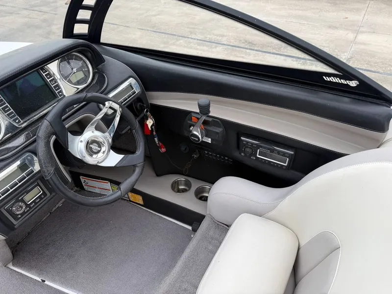Slide: The Image of Interior of a 2010 Malibu Wakesetter 23 LSV boat with steering wheel and dashboard. - 8