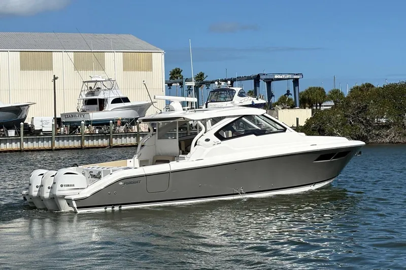 The Image of 2020 Pursuit DC 365 Dual Console boat on water, featuring Yamaha engines. - 1