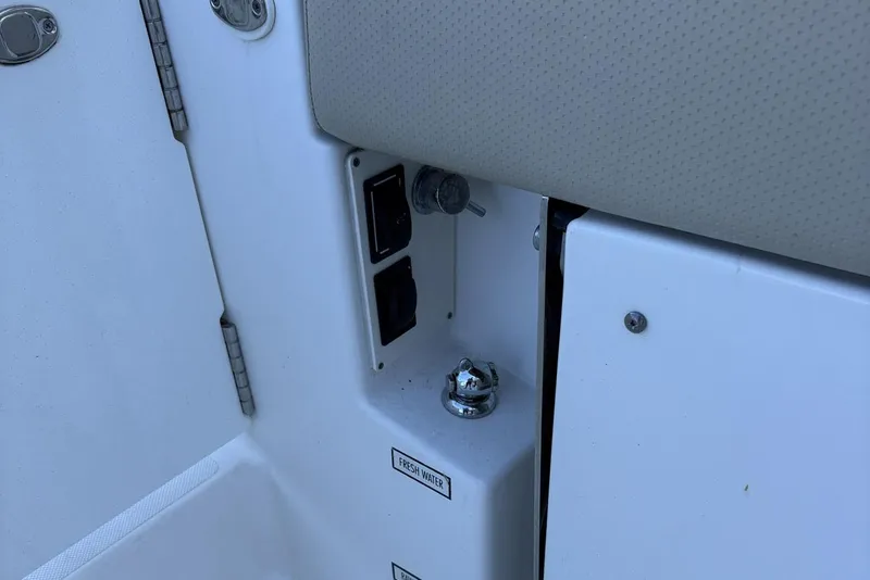 Slide: The Image of 2020 Pursuit DC 365 Dual Console boat interior detail with fresh water access. - 13