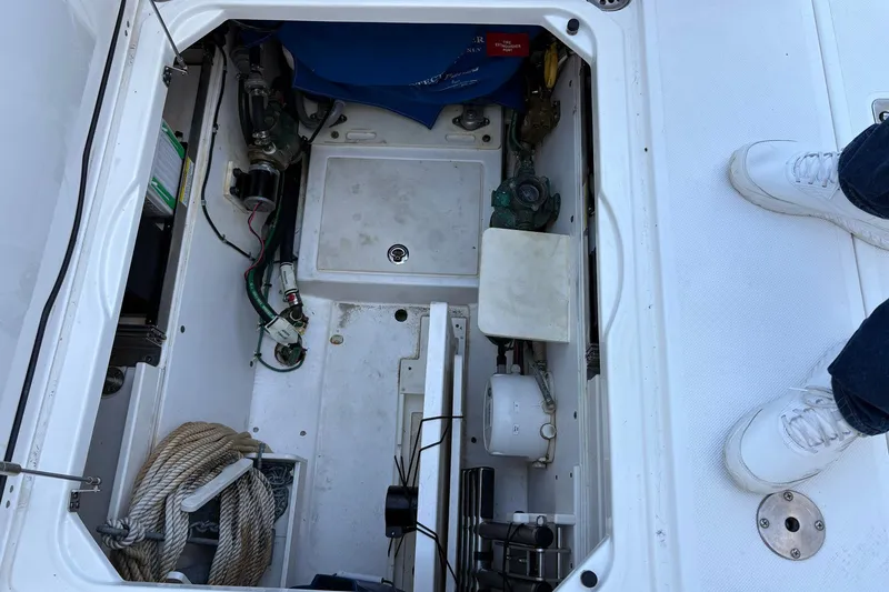 Slide: The Image of 2020 Pursuit DC 365 Dual Console boat storage compartment with ropes and equipment. - 14