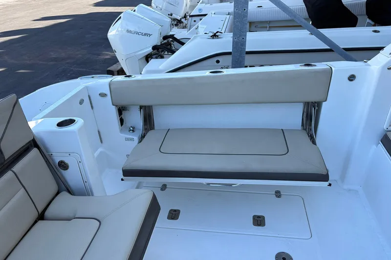 Slide: The Image of 2020 Pursuit DC 365 Dual Console boat interior with seating and Mercury engines. - 15
