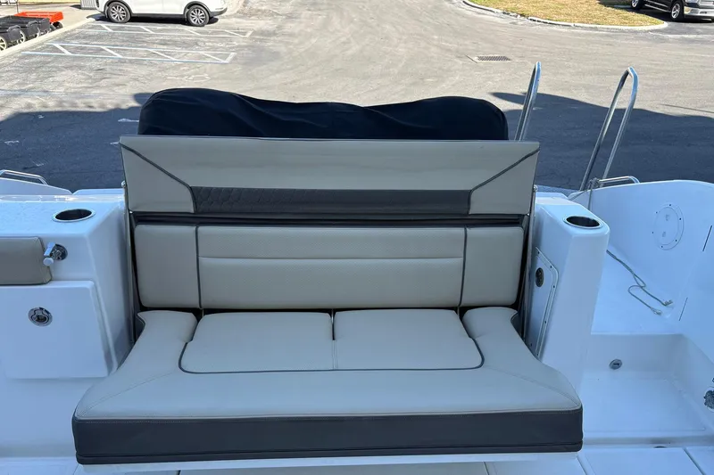 Slide: The Image of 2020 Pursuit DC 365 Dual Console boat with beige seating and cup holders. - 16